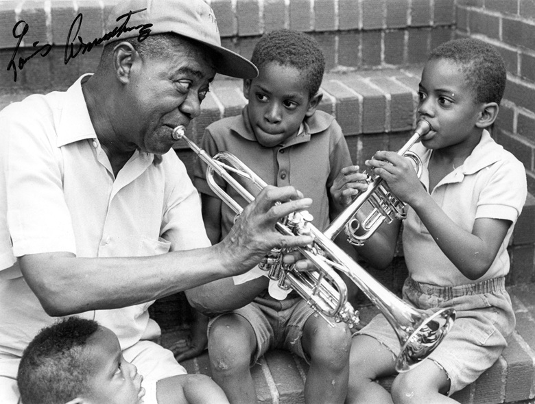 Louis Armstrong with neighbourhood children on the front steps of his home in Queens, New York, circa 1970. Archival image courtesy of the Louis Armstrong House Museum. Photo Chris Barham